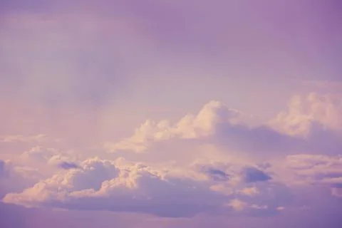Background of warm blue cloudy sky, sunny evening Stock Photos