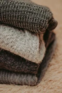 Background with warm sweaters. Pile of knitted clothes, warm background, knit Stock-Fotos
