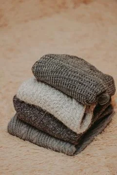 Background with warm sweaters. Pile of knitted clothes, warm background, knit Stock Photos