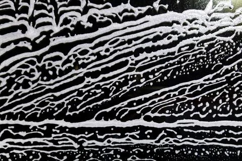 Background for washing windows, a lot of active foam on the glass, cleaning a Stock Photos