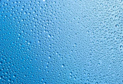 Background of water drops on gradient blue surface. Stock Photos