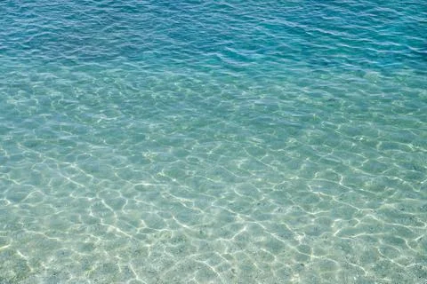 Background of water surface, sun's rays shimmer on water surface Stock Photos