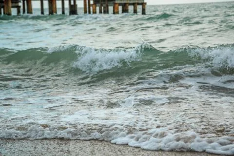 Background of waves beating on a sandy beach in stormy weather Stock Photos