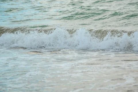 Background of waves beating on a sandy beach in stormy weather Stock Photos