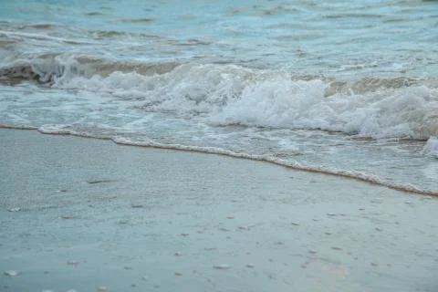 Background of waves beating on a sandy beach in stormy weather Stock Photos
