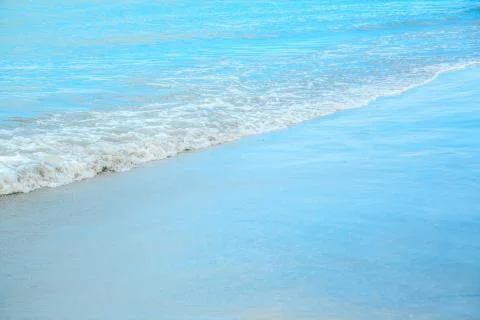Background of waves beating on a sandy beach in stormy weather Stock Photos