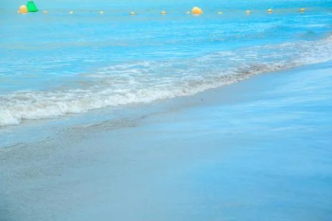 Background of waves beating on a sandy beach in stormy weather Stock Photos