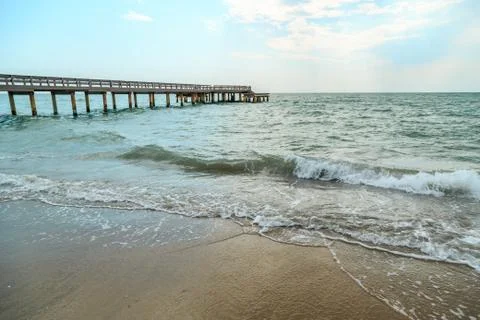 Background of waves beating on a sandy beach in stormy weather Stock Photos