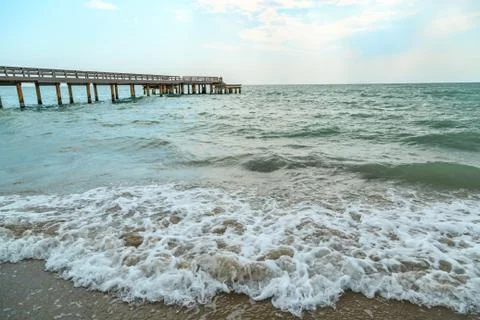 Background of waves beating on a sandy beach in stormy weather Stock Photos