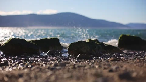Background Waves crashing on rocks on the beach. A light tide in the lagoon on Stock Footage 237906550
