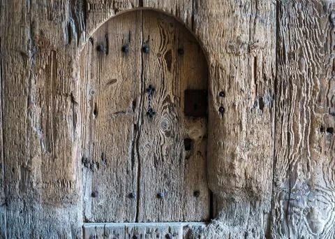 Background of weathered old rustic painted wood with a small door Stock Photos