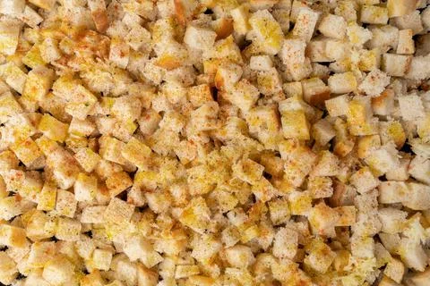 Background of white bread crackers. Slices of bread sprinkled with spices, to Stock Photos