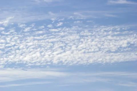 Background of white clouds on the background of blue sky. Stock Photos