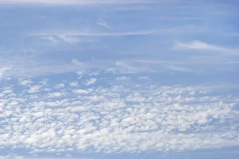 Background of white fluffy clouds on the background of blue sky. Stock Photos