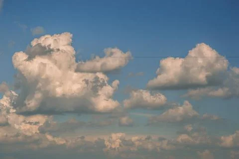 Background of white fluffy clouds in the blue sky.Close up Stock Photos