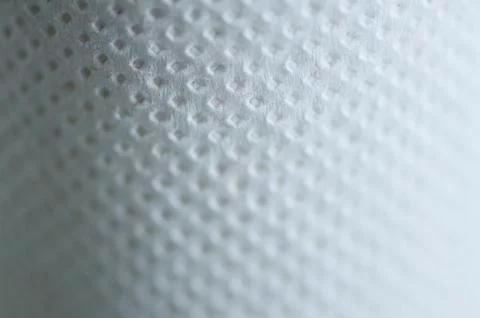 Background of white perforated texture. Focus, soft blur Stock Illustration