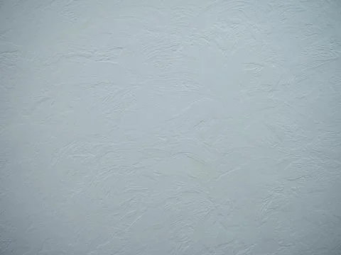 The background of white plaster applied to the walls with uneven strokes. Close Stock Photos