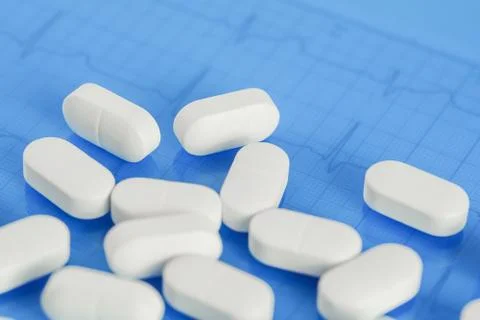 Background of white tablets or pills on the table. Medicine and pharmacy Stock Photos