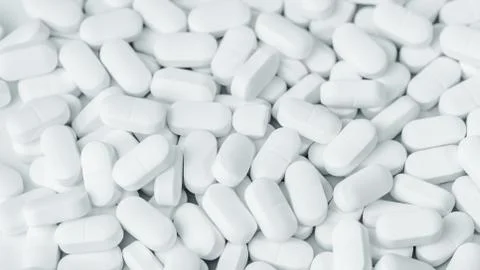 Background of white tablets or pills on the table. Medicine and pharmacy Stock Photos