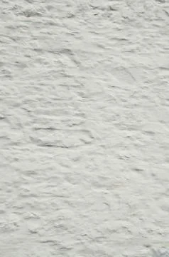 Background of whitewashed old stone wall that is rough and grung Stock Photos