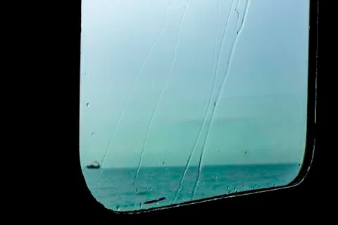 Background of window on boat in raining day, Water droplets flow along the gl Stock Photos