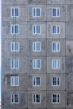 Background of windows wall of panel box building of cheap housing 스톡 사진