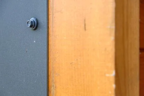 Background wood with metal, a bolt is screwed into the metal Stock Photos