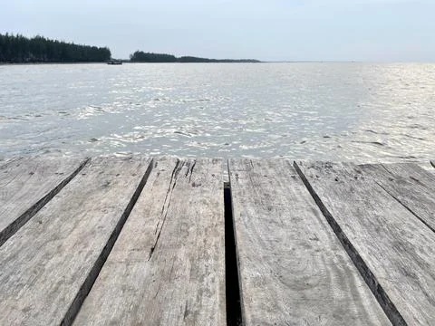 The background is a wooden deck with a pattern of longitudinal lines Stock Photos