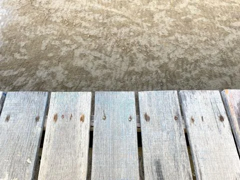 The background is a wooden deck with a pattern of longitudinal lines Stock Photos