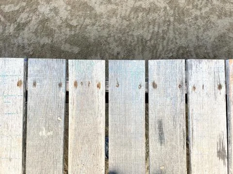 The background is a wooden deck with a pattern of longitudinal lines Foto stock