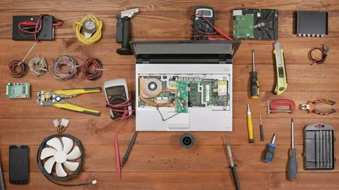 Background: Workplace of engineer repair laptops. Disassembled computer and Stock Footage 72420376