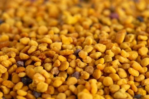 A Background of Yellow Bee Pollen Pellets Stock Photos