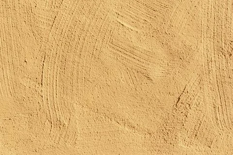 Background of yellow painted plaster wall in rough structure Stock Photos