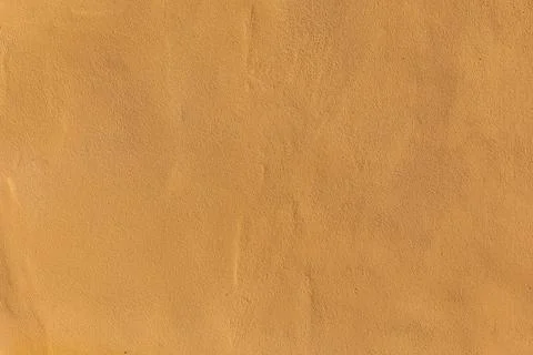 Background of yellow plaster on the wall. Stock Photos