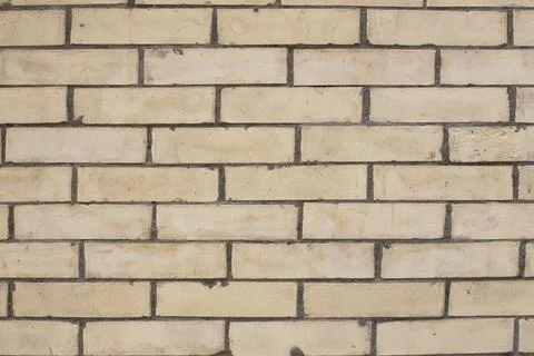 The background of yellow stone wall. Stock Photos