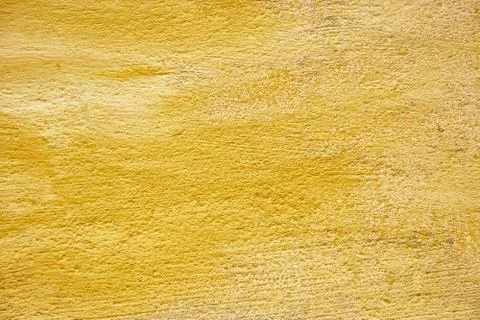Background yellow texture. Hard old painted wall in grunge style. Surface for Stock Photos