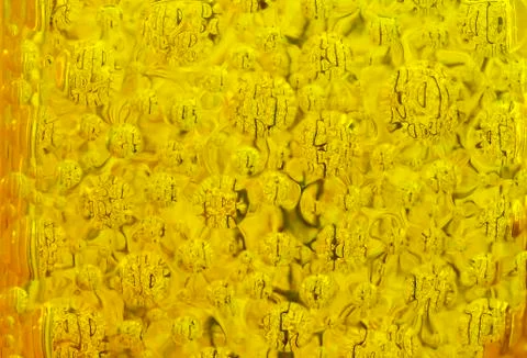 Background of yellow transparent glass with reflections. Stock Photos