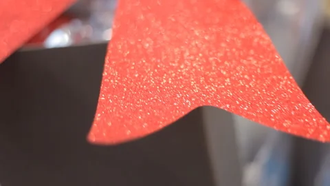 Background:Huge red sparkling bow on the background of the inscription Christmas Stock Footage 98569439