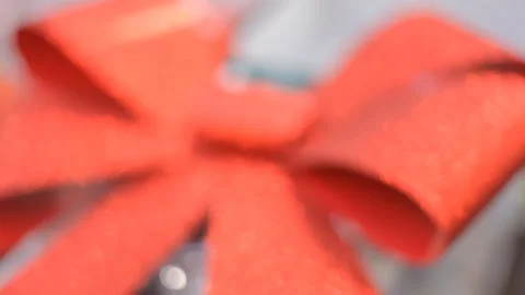 Background:Huge red sparkling bow on the background of the inscription Christmas Stock Footage 98569457