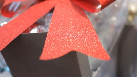 Background:Huge red sparkling bow on the background of the inscription Christmas Video stock 98569469