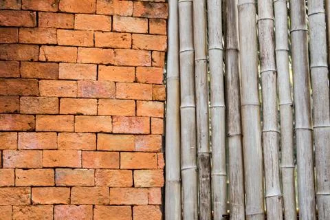 Backgrounds and pattern of ancient brick walls orange and old bamboo fence li Stock Photos