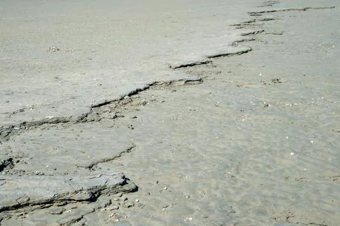 Backgrounds. Close up of a crack in a sandy surface Stock Photos