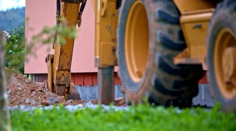 Backhoe boom arm reaching deep in hole long shot Stock Footage 61244358