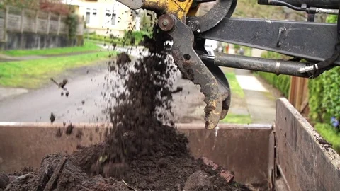 Backhoe bucket dumping soil Stock Footage 74837287