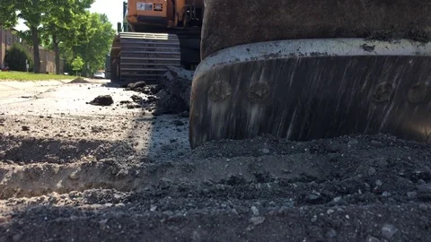 Backhoe Close Up Scraping Road 스톡 동영상 77143179