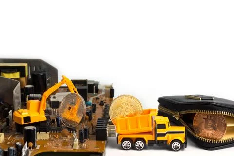 Backhoe dig bitcoin on mainboard. Stock Photos