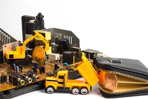 Backhoe dig bitcoin on mainboard. Stock Photos