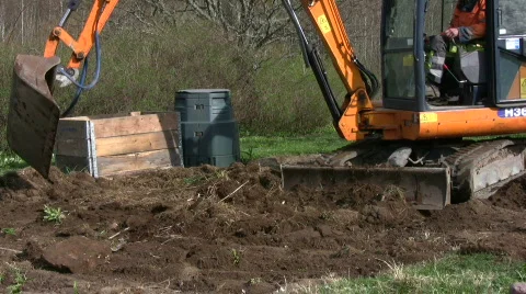 Backhoe dig in a garden Stock Footage 703834