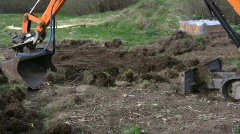 Backhoe dig in a garden Stock Footage 704336