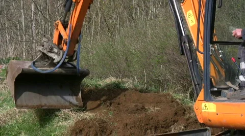 Backhoe dig in a garden Stock Footage 704384